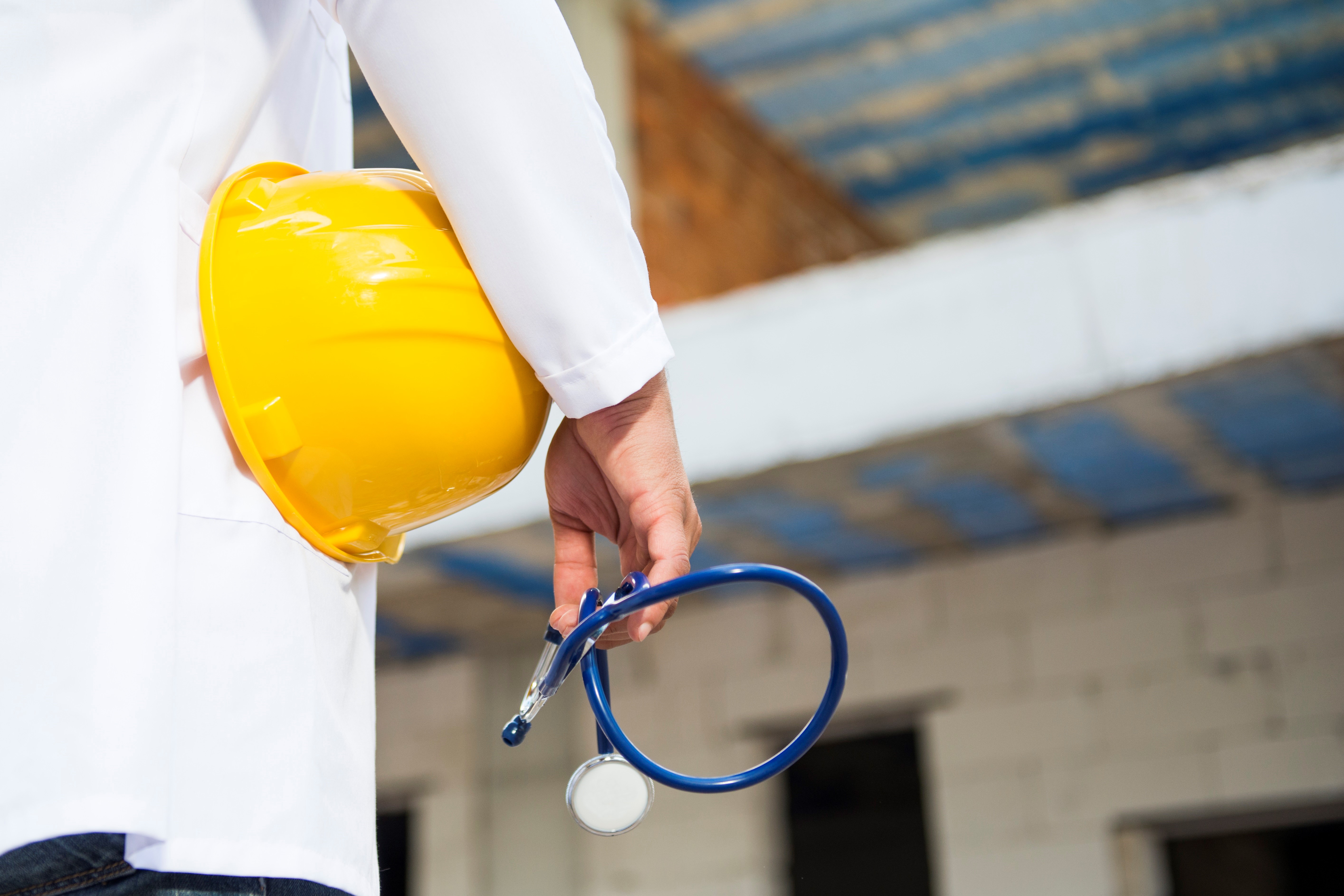 image of doctor holding hard hat and stethoscope